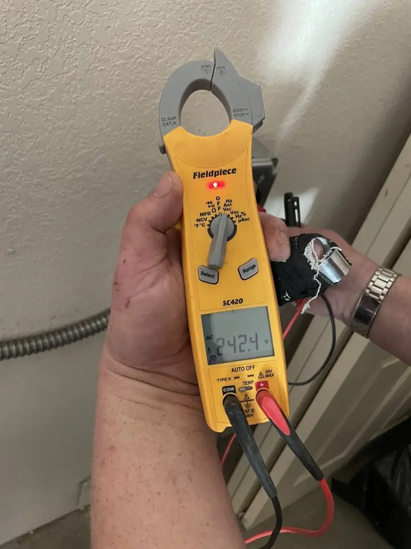 Voltage testing with clamp meter during Outlet Installation in Penitas